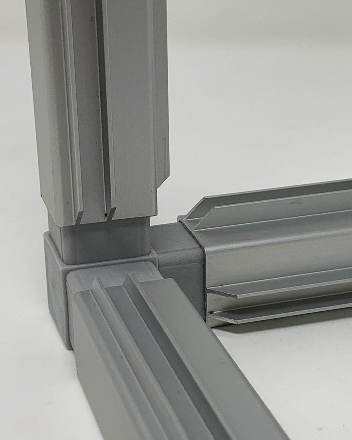 Extruded metal profiles joined at a corner.