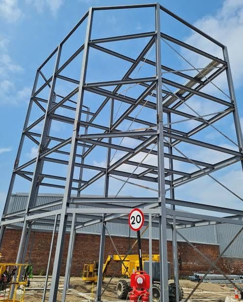 A multi-storey steel frame standing on site.